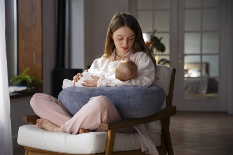 woman-using-nursing-pillow-home-newborn-baby